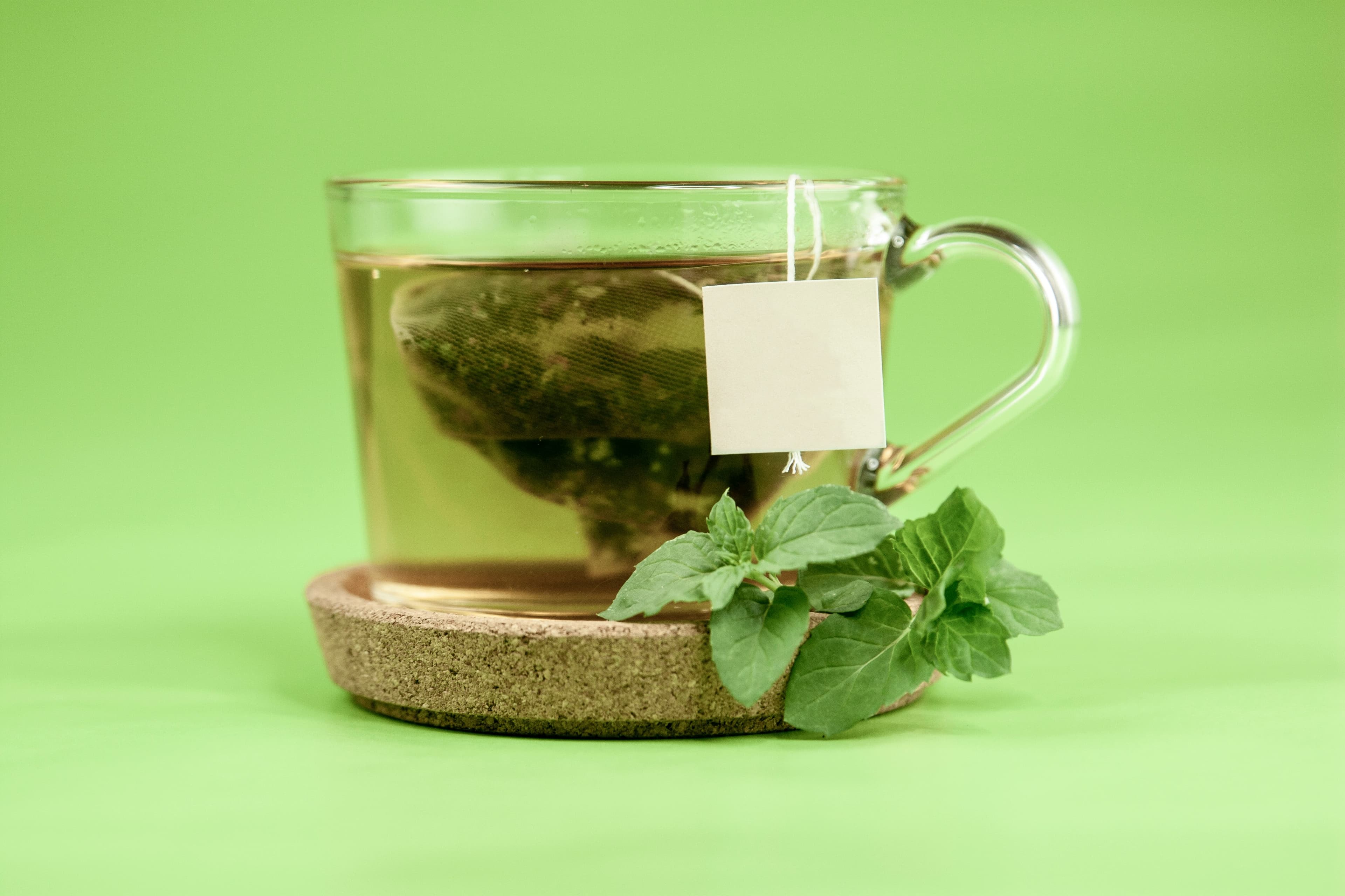 Dried herbs, tea, and aromatherapy oils arranged on linen